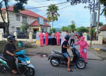 Pengurus Bhayangkari Ranting Polsek Wara bersama personel Polsek Wara menggelar kegiatan berbagi makanan takjil bagi para pengendara