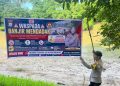 Kapolsek Lamuru Pasang Spanduk Imbauan Kamtibmas Antisipasi Banjir dan Tanah Longsor